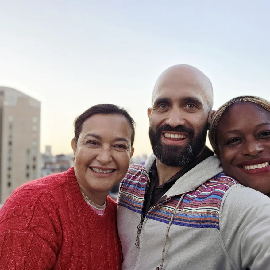Gabriel Perez, Nexrizen co-founder, with two Nexrizen clients on a rooftop at sunset.